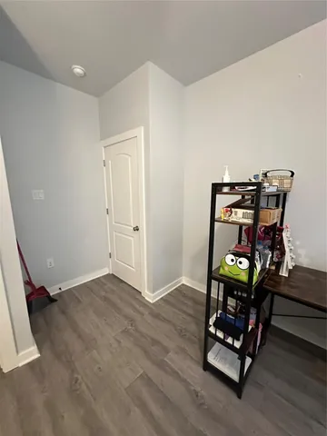 a view of a room with wooden floor furniture and windows