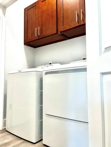 a view of a refrigerator with cabinet
