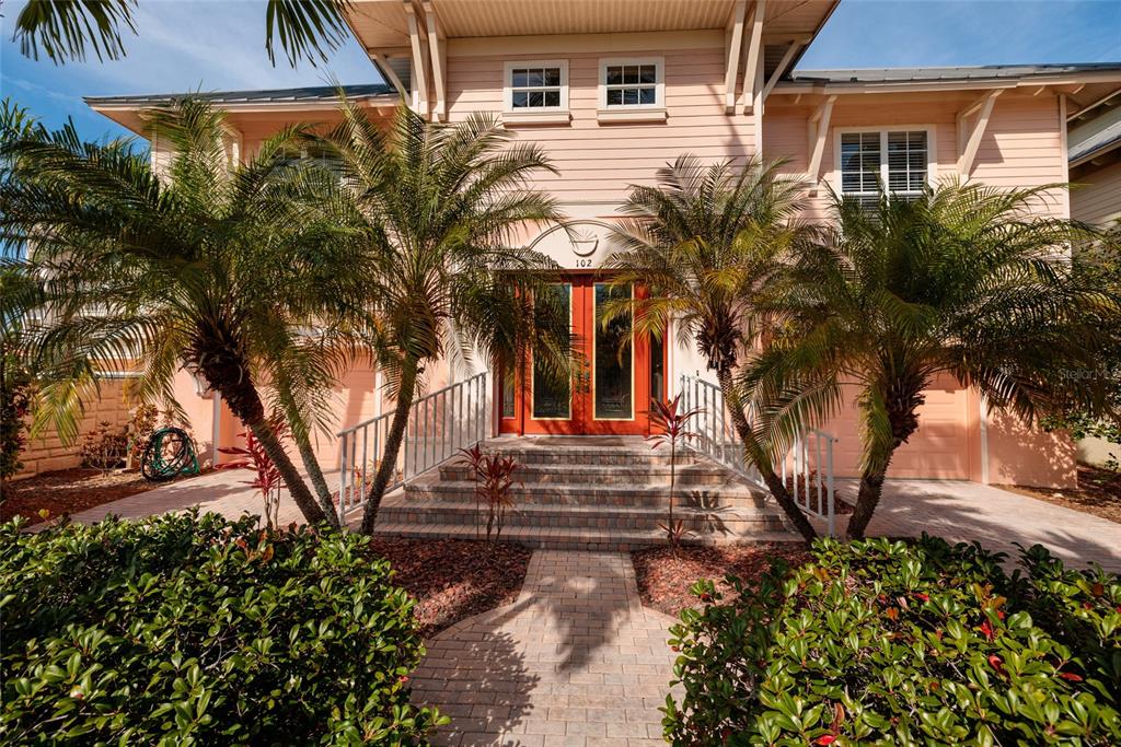 a front view of a house with garden