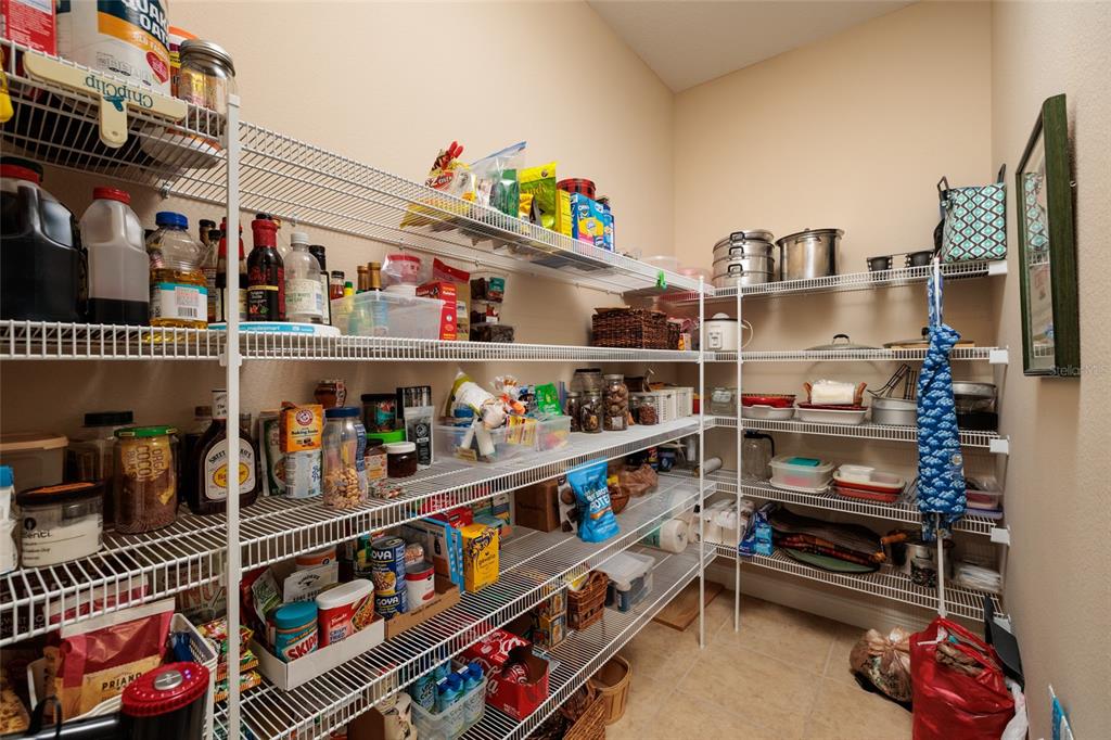 102 Wimbledon Court Redington Shores, FL 33708 - Photo 12 of 66 a room with lots of books and a refrigerator