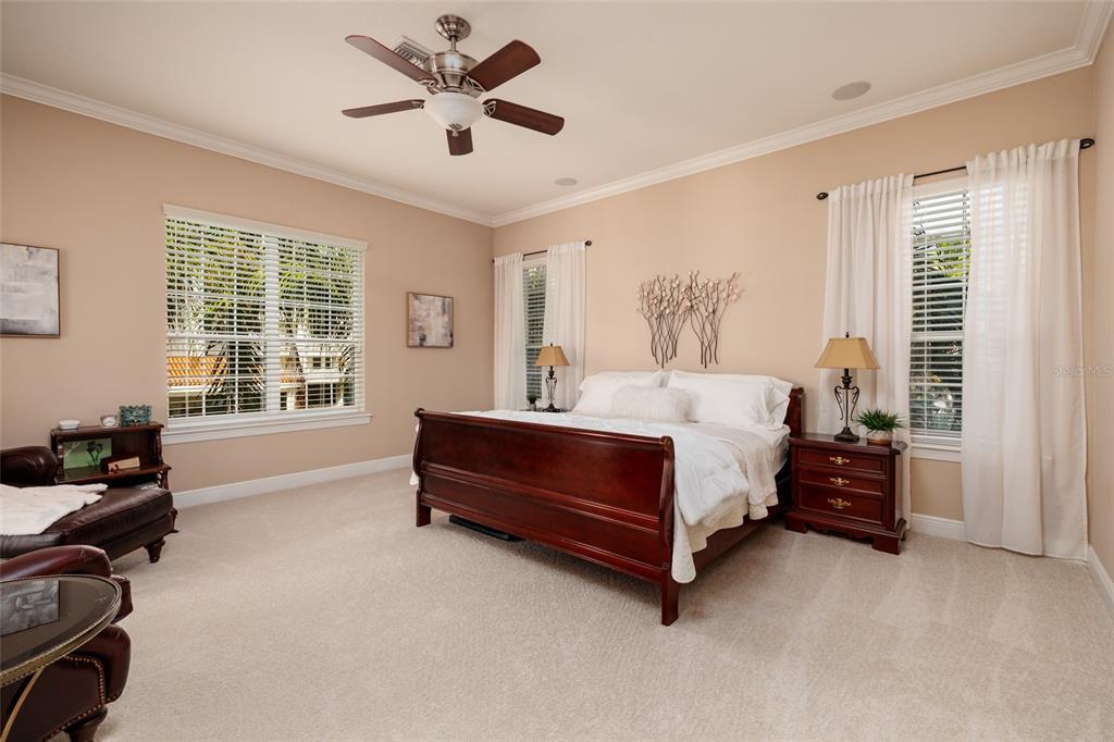 102 Wimbledon Court Redington Shores, FL 33708 - Photo 13 of 66 a bedroom with a bed and a large window