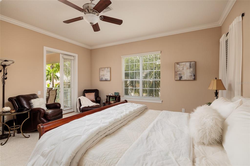 102 Wimbledon Court Redington Shores, FL 33708 - Photo 15 of 66 a bedroom with double bed windows and a chandelier