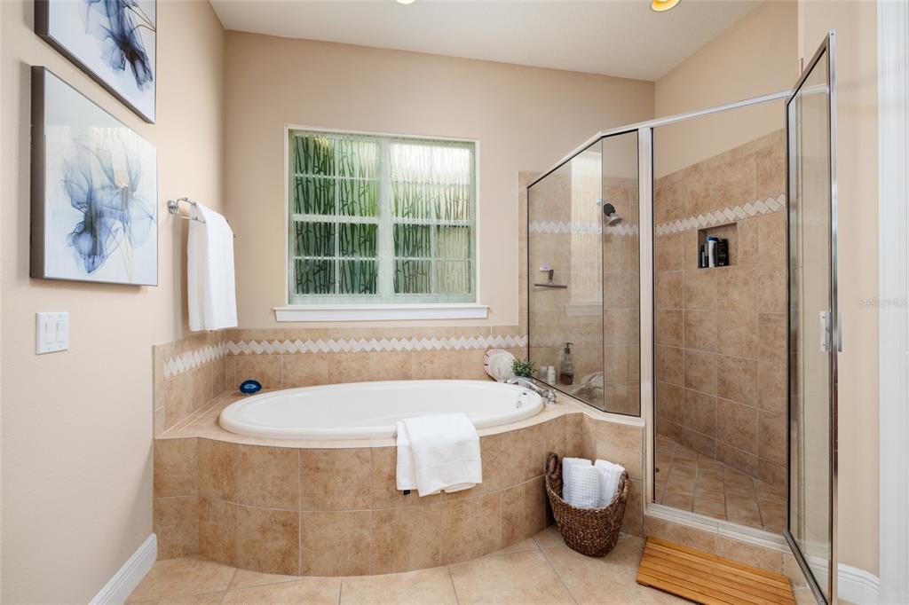 102 Wimbledon Court Redington Shores, FL 33708 - Photo 17 of 66 a bathroom with a tub and a shower
