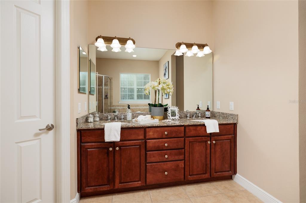 102 Wimbledon Court Redington Shores, FL 33708 - Photo 18 of 66 a bathroom with a double vanity sink and a mirror