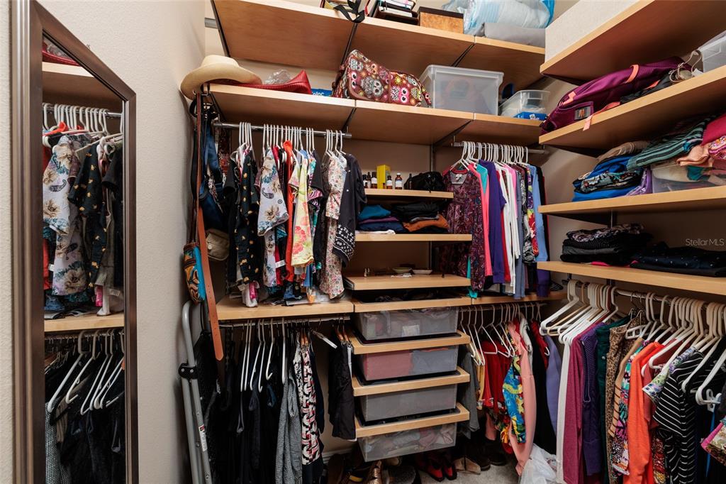 102 Wimbledon Court Redington Shores, FL 33708 - Photo 19 of 66 a view of walk in closet with clothes and shoes