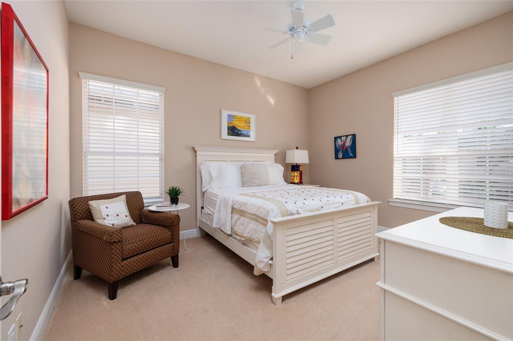 102 Wimbledon Court Redington Shores, FL 33708 - Photo 22 of 66 a bedroom with a bed and a couch