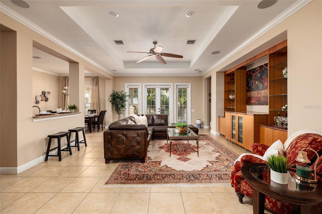 102 Wimbledon Court Redington Shores, FL 33708 - Photo 25 of 66 a living room with furniture and large windows