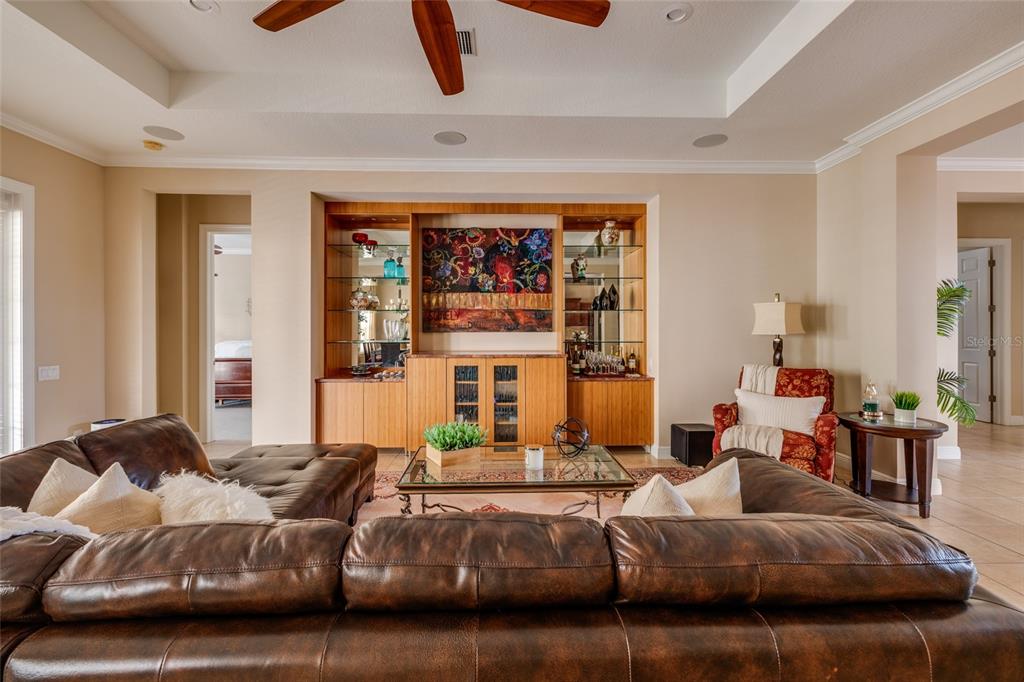 102 Wimbledon Court Redington Shores, FL 33708 - Photo 27 of 66 a living room with furniture and a large window