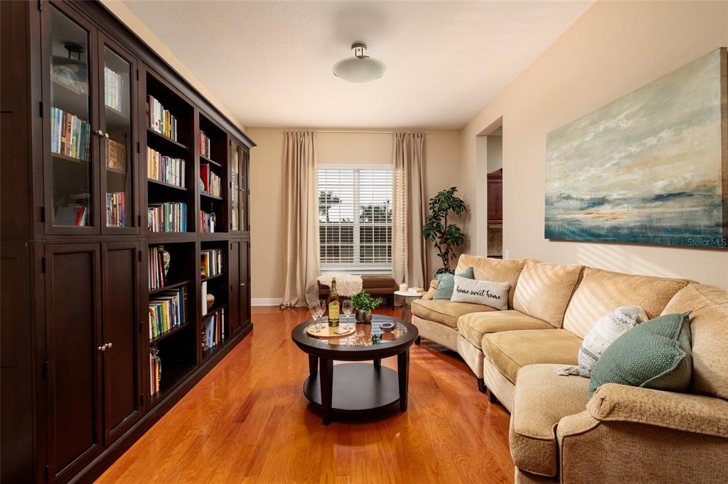 102 Wimbledon Court Redington Shores, FL 33708 - Photo 28 of 66 a living room with furniture and a book shelf
