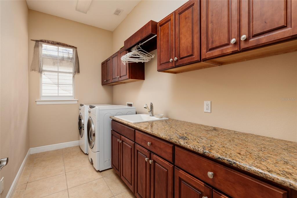 102 Wimbledon Court Redington Shores, FL 33708 - Photo 29 of 66 a kitchen with stainless steel appliances granite countertop a sink stove and microwave