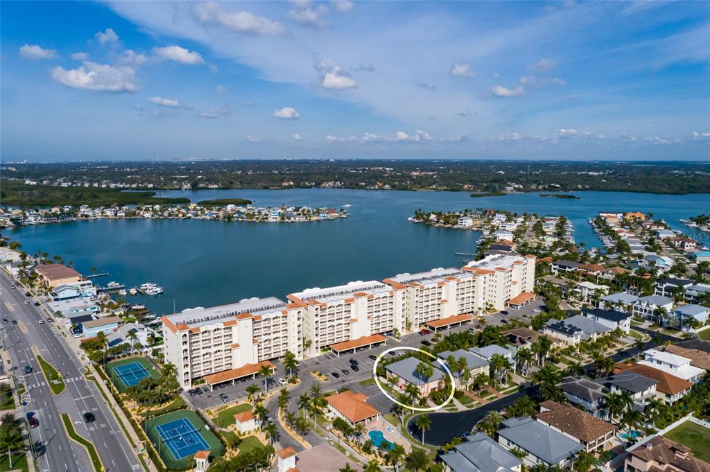 102 Wimbledon Court Redington Shores, FL 33708 - Photo 34 of 66 an aerial view of a houses with a lake view