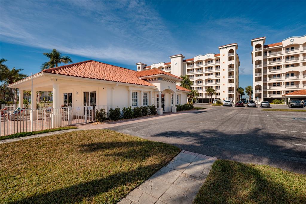 102 Wimbledon Court Redington Shores, FL 33708 - Photo 40 of 66 a front view of a building with a garden