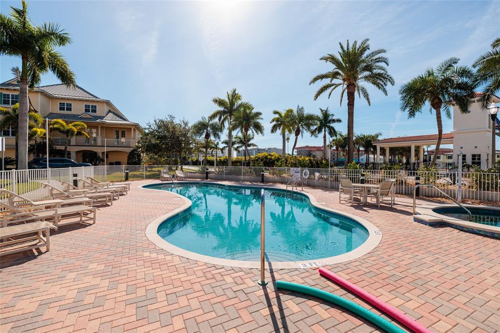 102 Wimbledon Court Redington Shores, FL 33708 - Photo 42 of 66 a swimming pool with outdoor seating and yard