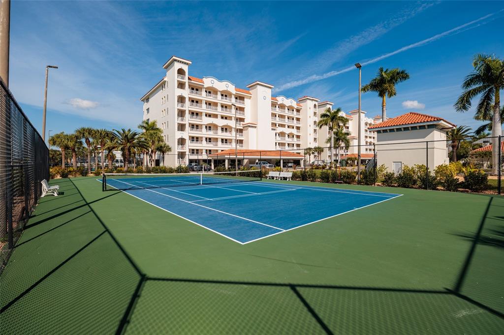 102 Wimbledon Court Redington Shores, FL 33708 - Photo 45 of 66 a view of a tennis ground with large windows