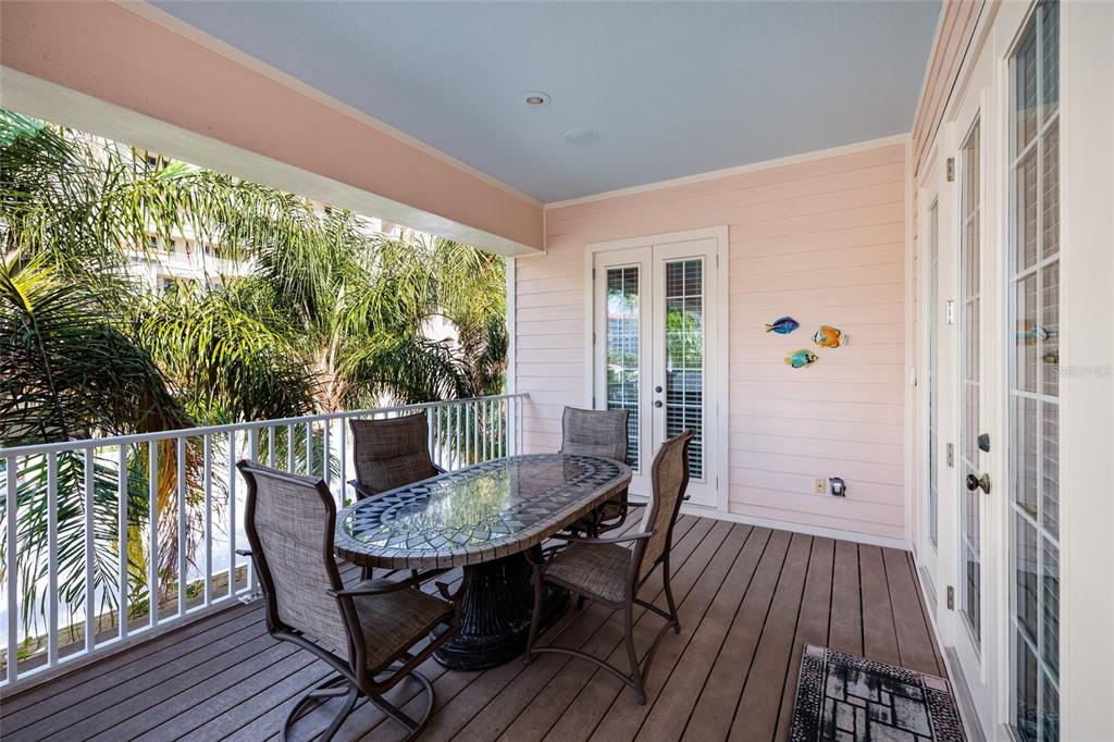 102 Wimbledon Court Redington Shores, FL 33708 - Photo 52 of 66 a view of balcony with furniture and wooden deck