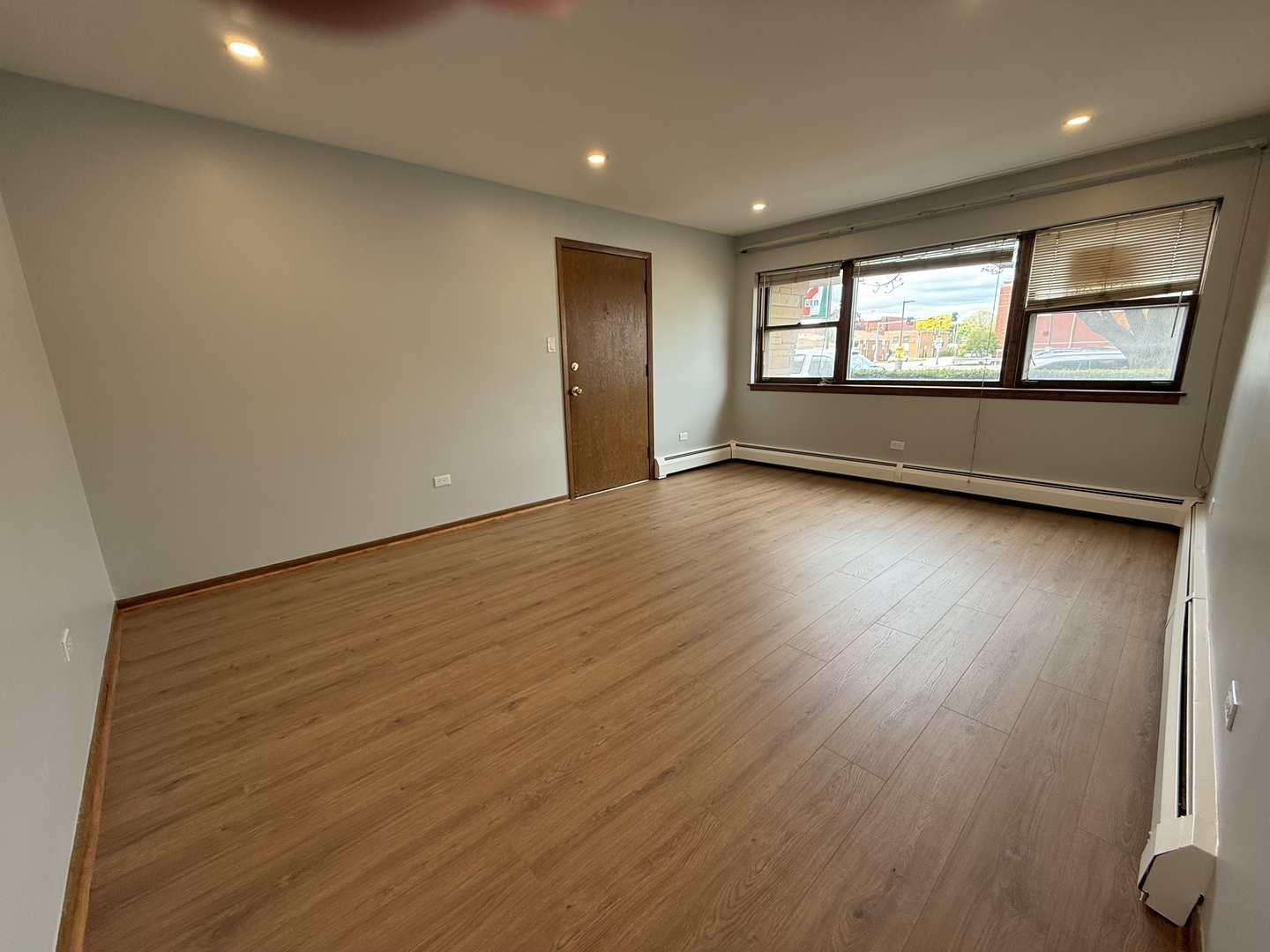 6543 16th Street, Unit 1N Berwyn, IL 60402 - Photo 4 of 11 an empty room with wooden floor and windows