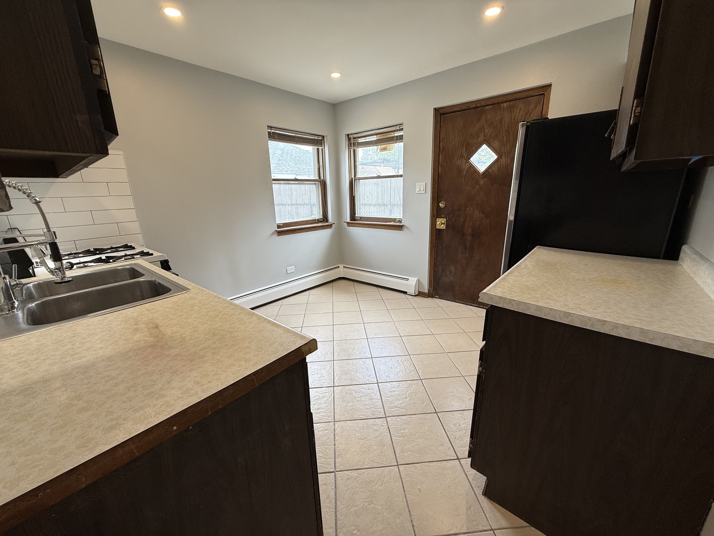 6543 16th Street, Unit 1N Berwyn, IL 60402 - Photo 6 of 11 a kitchen with a sink refrigerator and stove