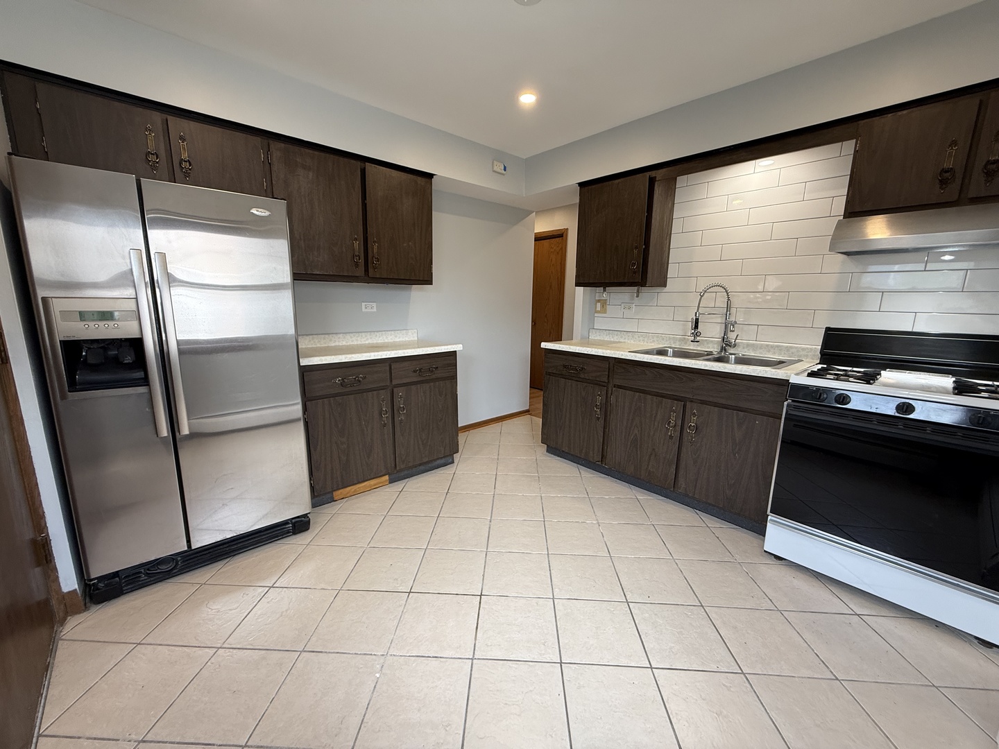 6543 16th Street, Unit 1N Berwyn, IL 60402 - Photo 7 of 11 a kitchen with stainless steel appliances granite countertop a refrigerator and a stove top oven