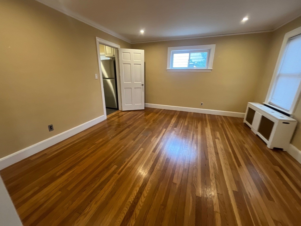 30 Stearns Road Belmont, MA 02478 - Photo 6 of 24 an empty room with wooden floor and windows