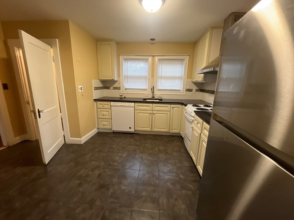 30 Stearns Road Belmont, MA 02478 - Photo 9 of 24 a kitchen with stainless steel appliances granite countertop a refrigerator a stove and a sink