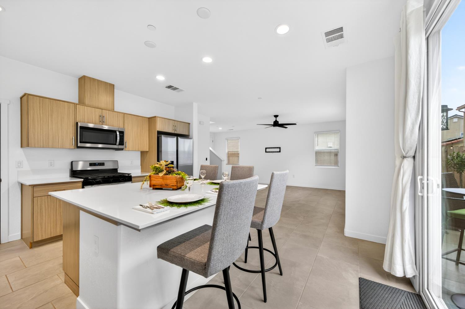 317 Talus Way South Madera, CA 93636 - Photo 13 of 61 a kitchen that has a dining table and chairs in it
