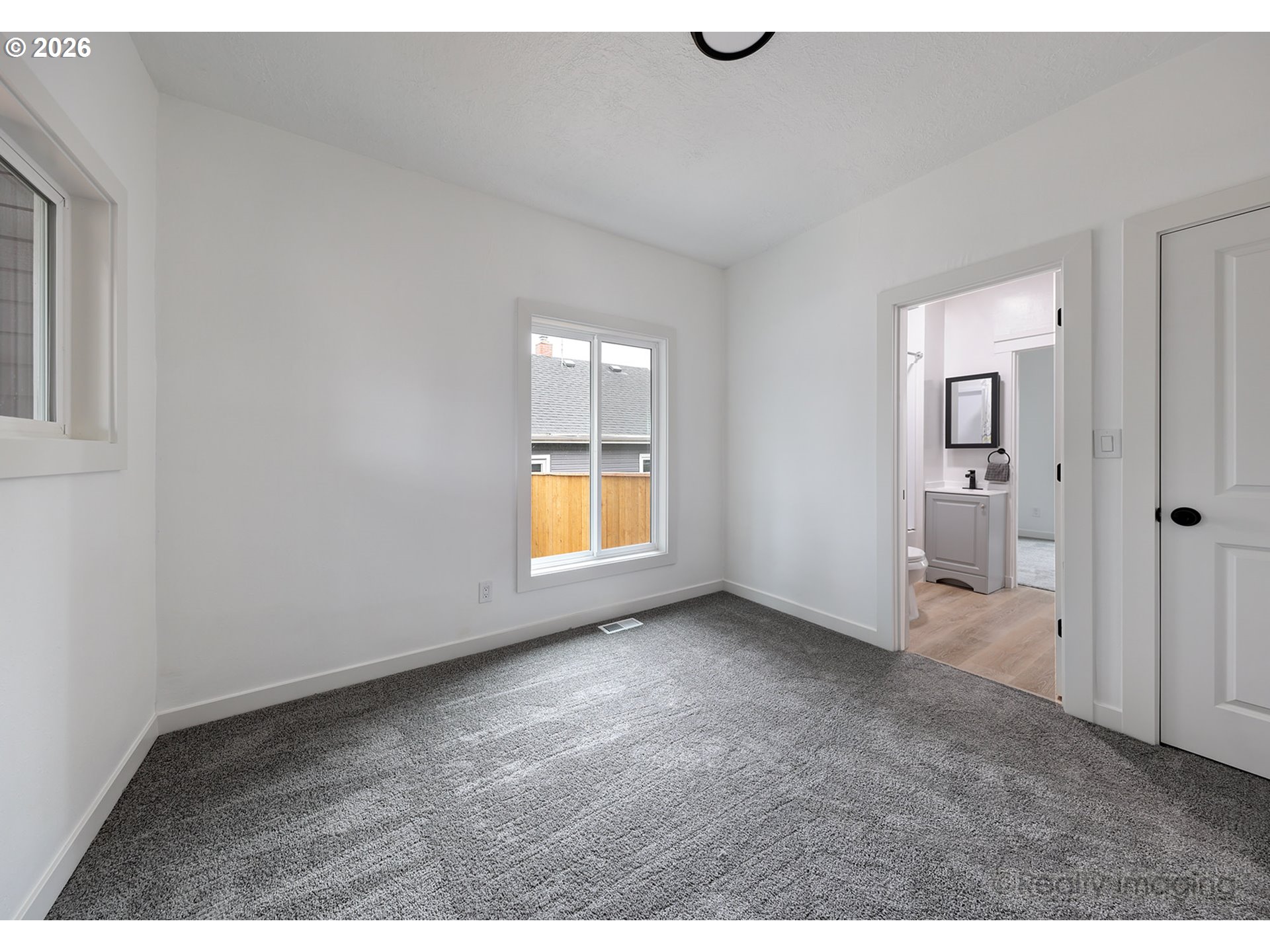 9004 Southeast Claybourne Street Portland, OR 97266 - Photo 8 of 15 view of empty room with windows
