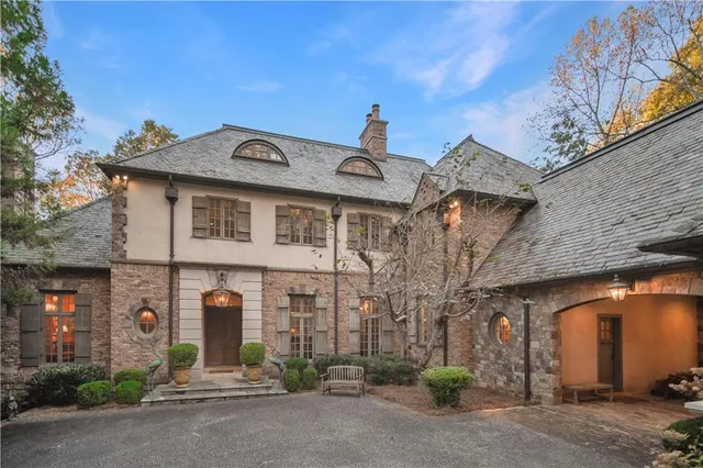 a front view of a house with parking area