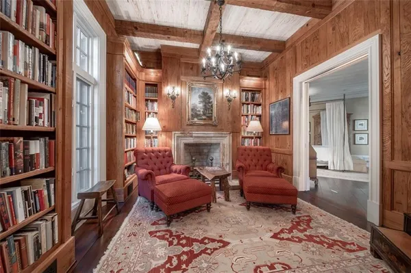 a living room with furniture a fireplace and a large window