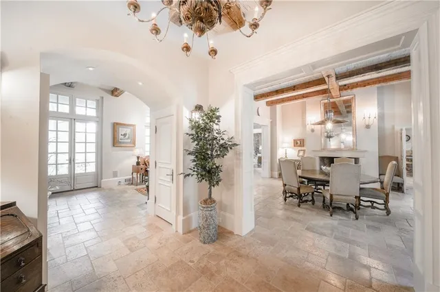 a living room with furniture a rug wooden floor and a large window