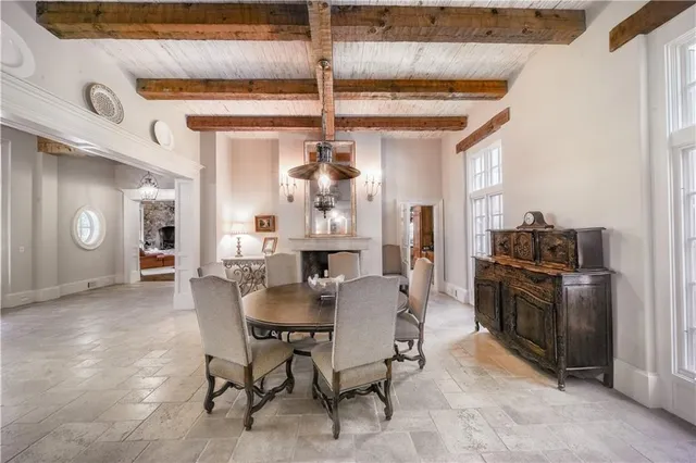 a living room with furniture a fireplace and a table