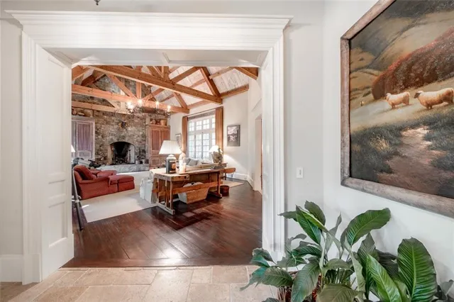 a living room with furniture a fireplace and a large window