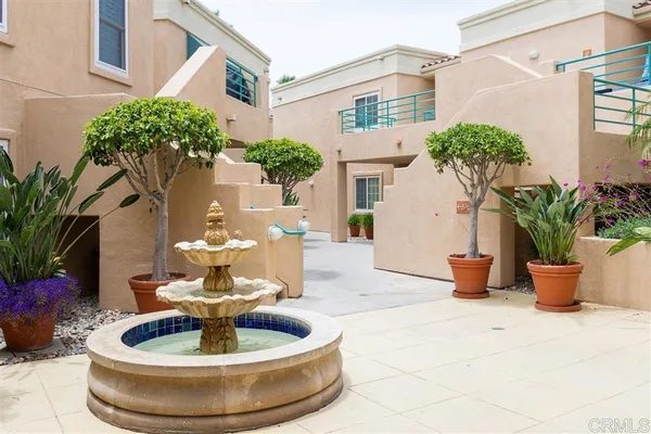 a view of a house with potted plants