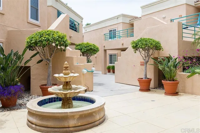 a view of a house with potted plants