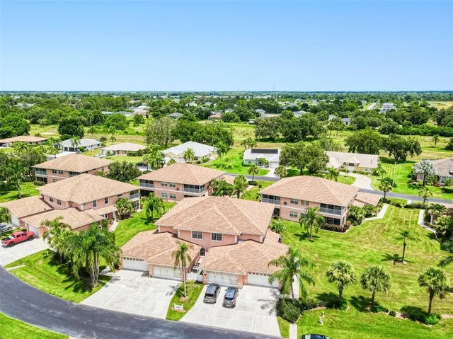 an aerial view of residential houses with outdoor space and street view