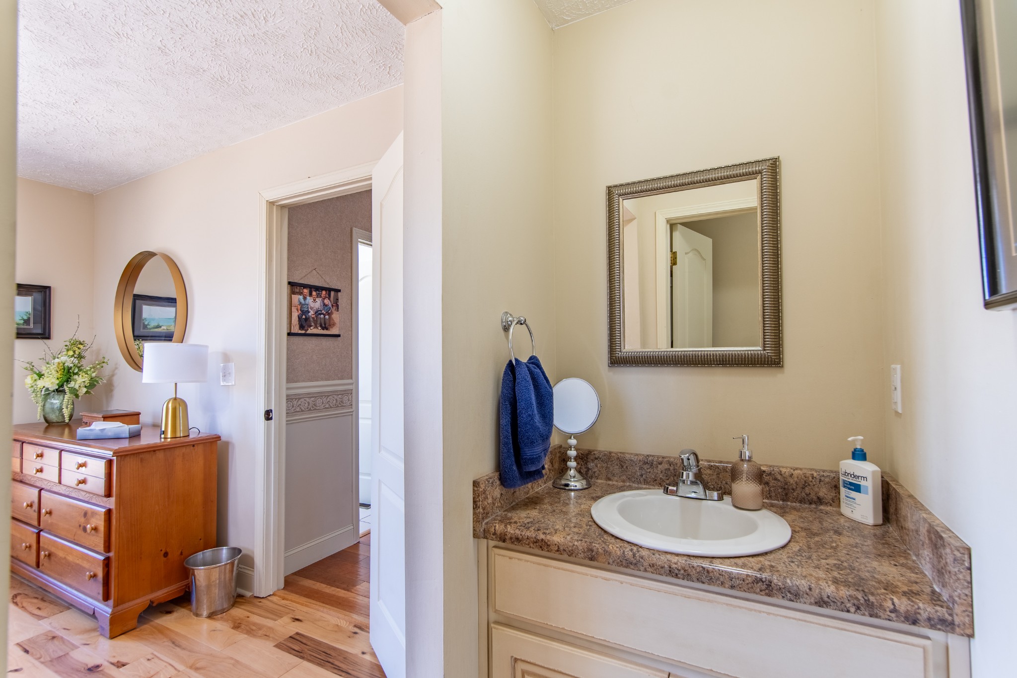 115 Tanyard Circle Adamsville, TN 38310 - Photo 23 of 52 a bathroom with a granite countertop sink and a mirror