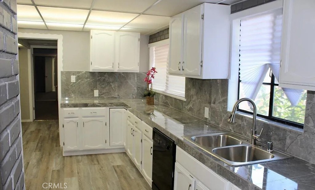 3213 Bucknell Street Bakersfield, CA 93305 - Photo 2 of 2 a kitchen with stainless steel appliances granite countertop a sink stove and cabinets