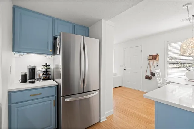 a kitchen with stainless steel appliances a refrigerator sink and cabinets
