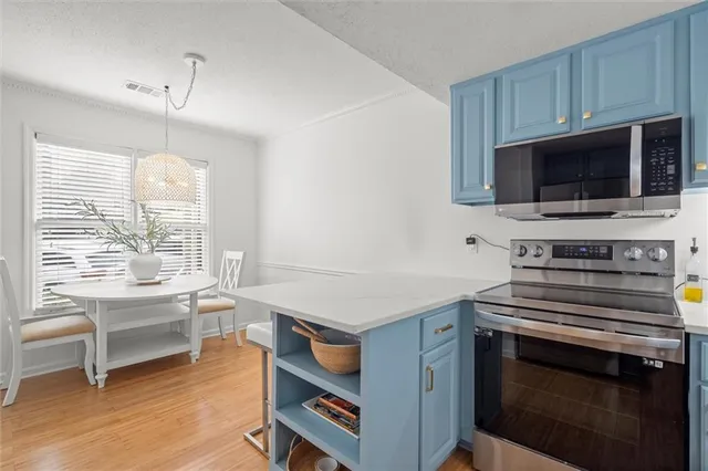 a kitchen with a stove and a microwave