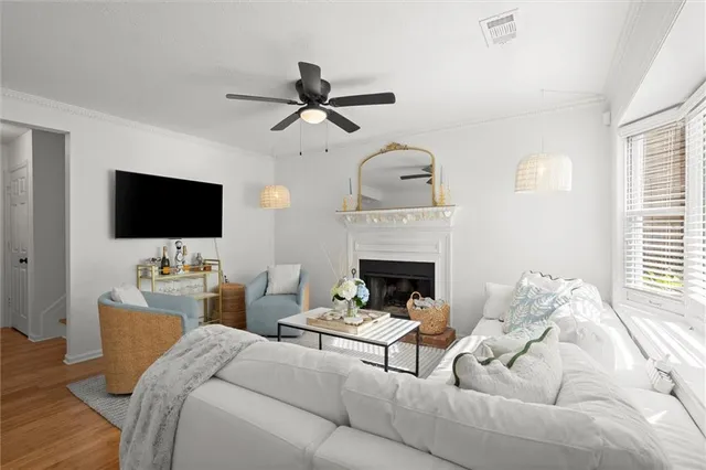 a living room with furniture a flat screen tv and a fireplace