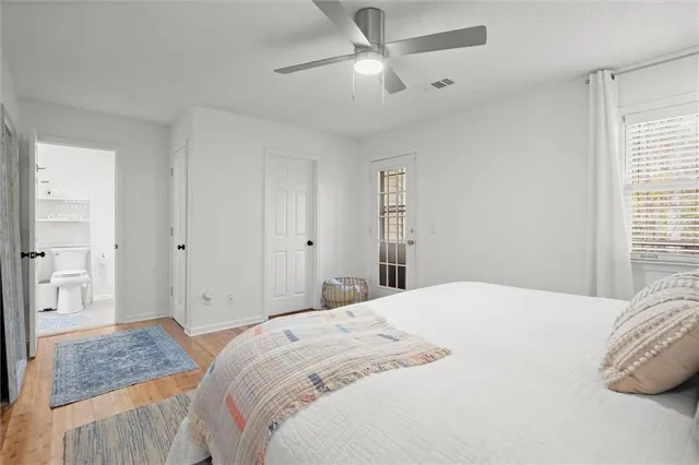a bedroom with a large bed and a chandelier