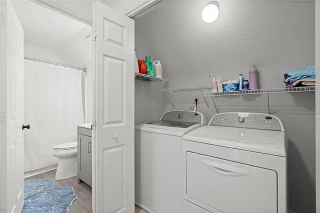 a view of bathroom with a washer and dryer