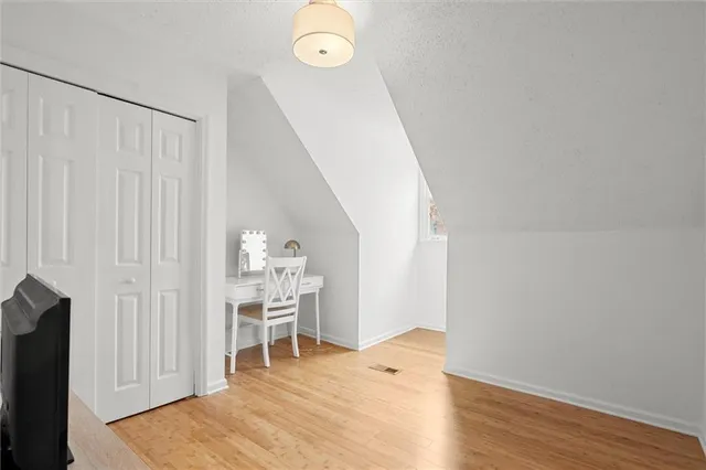 a view of a room with wooden floor lounge chair and windows