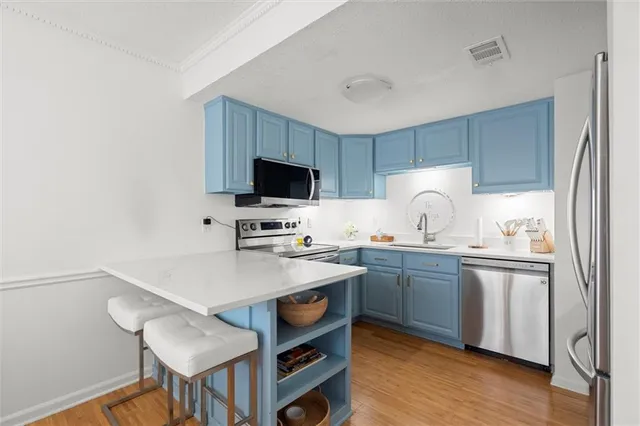 a kitchen with a stove a sink and a refrigerator