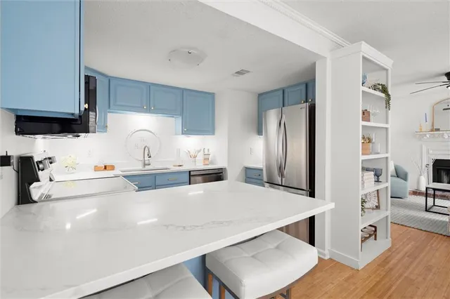 a kitchen with stainless steel appliances a refrigerator and a stove