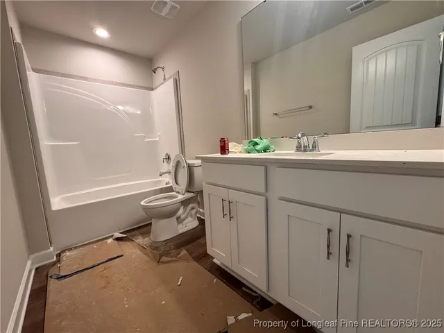 a room with a sink cabinets and wooden floor