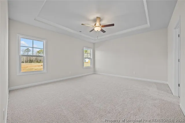 a view of an empty room with a window and fireplace