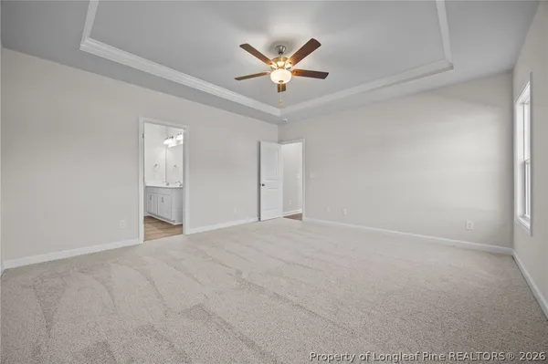 a kitchen with stainless steel appliances granite countertop a stove a sink a microwave a refrigerator a sink and white cabinets