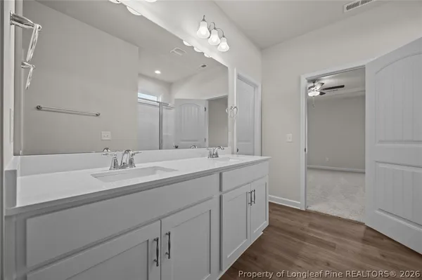 a large kitchen with cabinets wooden floor and stainless steel appliances