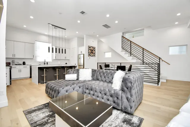 a living room with furniture and kitchen view
