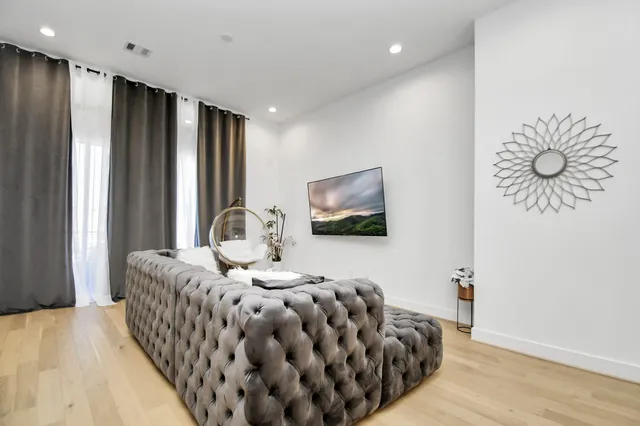 a bedroom with a bed and a flat screen tv